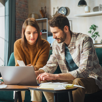 Thumbnail of two small business owners evaluating their budget.
