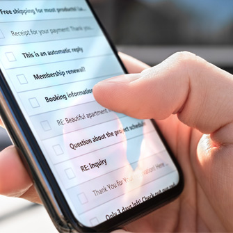 A person scrolling through their email inbox on a smart phone.