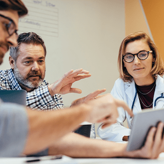 A medical team reviews documents and discusses their hospital marketing plan.