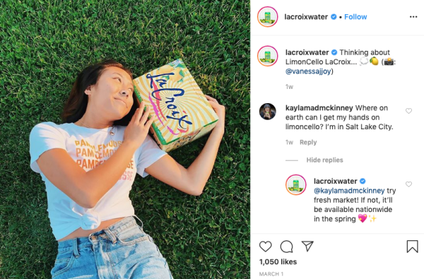 User-generated content by LaCroix on Instagram. A woman holds a box of LaCroix while lying in the grass.