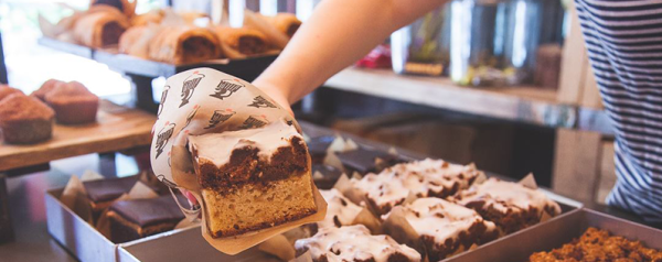 Brownies being served by a bakery worker
