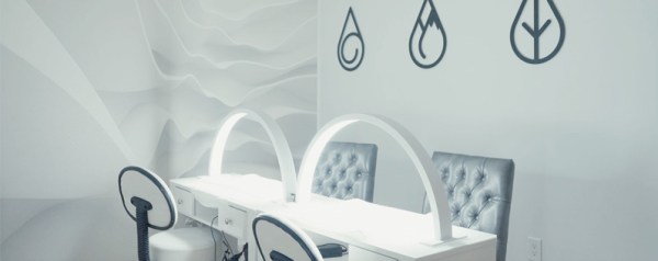 A wide shot of a modern spa interior with a gray and black motif