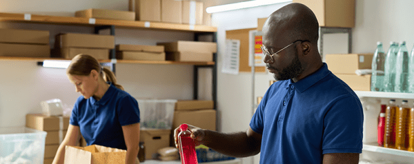 Volunteers fill bags at a food bank.