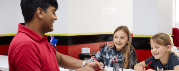 A maths instructor with two enthusiastic students.