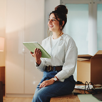 A woman thinking in office with her tablet.