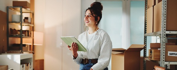 A woman thinking in office with her tablet.