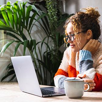 A woman looking at her laptop.