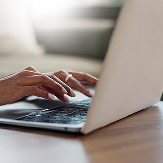 This image captures a top-down view of someone typing on a laptop.