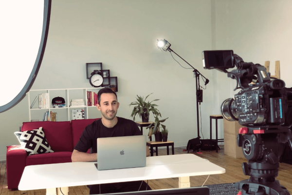 Ecommerce email marketing consultant Chase Dimond sitting on his  desk with the laptop in front of him filming a video.