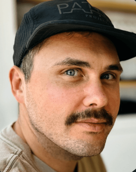 Email design specialist Matt Helbig wearing a cap.