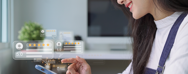 A woman holds a smartphone among images of five-star customer reviews.