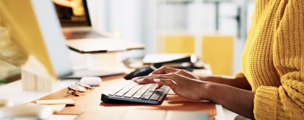 A woman typing on a keyboard