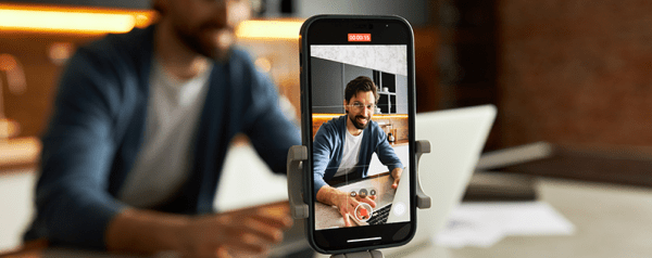 A man filming a video with his smartphone