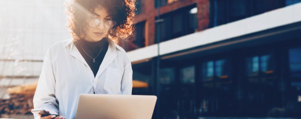 A woman perusing a website on her laptop.