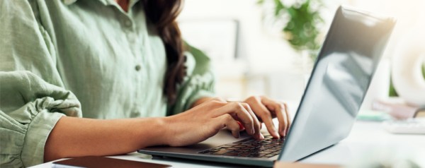 A woman typing on her laptop
