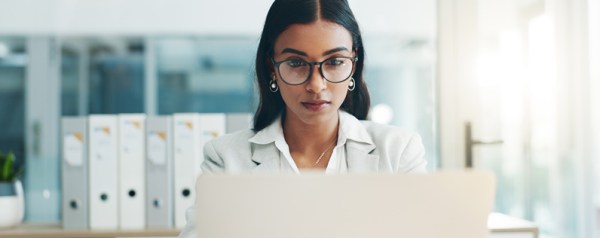 A professional woman sitting in front of a computer.