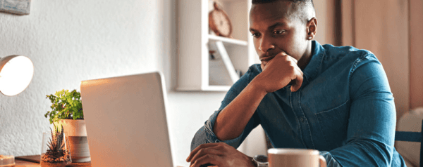 A man looking at his laptop