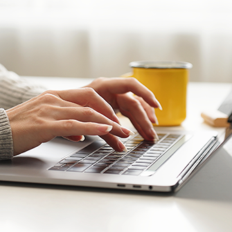 A person typing on a laptop
