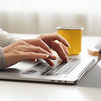 A person typing on a laptop