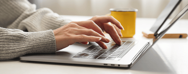 A person typing on a laptop